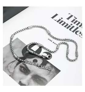 Macro view of a trendy titanium steel box chain necklace featuring cylindrical segment details