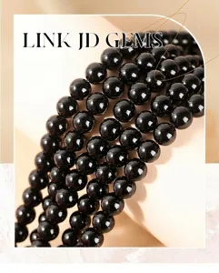 Detailed macro view of polished natural black obsidian round beads for DIY jewelry making