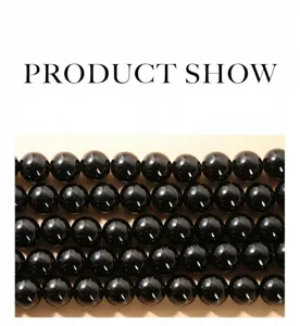 Close-up detail of glossy natural black obsidian round loose beads