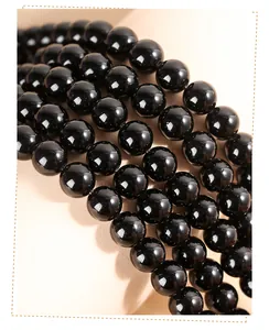 Détail macro de perles rondes en obsidienne noire naturelle pour bijoux artisanaux