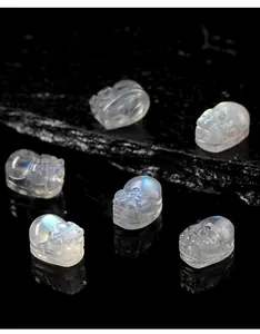 Macro detail of carved grey moonstone Pixiu beads showing natural blue flash light