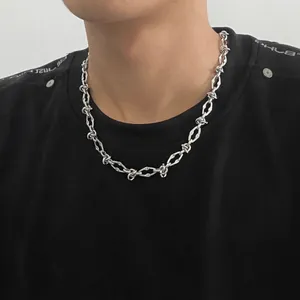 Detail of a men's silver titanium steel chain necklace with edgy streetwear style