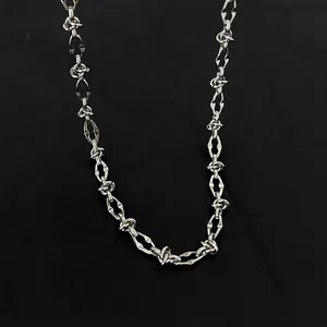 Detailed close-up of a silver titanium steel hip-hop chain necklace on black background