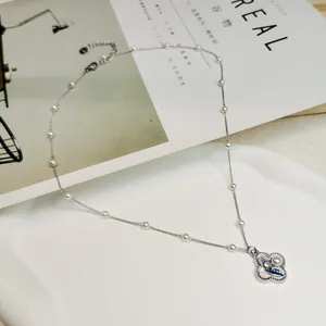 Vintage silver necklace with delicate pearl beads and floral enamel pendant details
