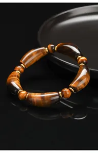 Detailed close-up of natural yellow tiger's eye bracelet with polished horn-shaped beads