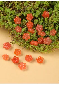 Close-up of translucent orange carved agate flower beads for DIY jewelry making