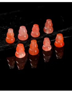Detailed view of translucent cherry red Nanhong agate gourd beads for jewelry DIY.