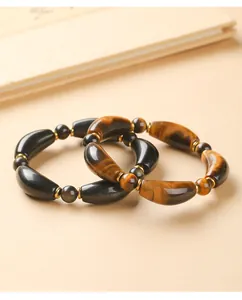 Detailed view of Tiger Eye and Black Obsidian curved tube beaded bracelets