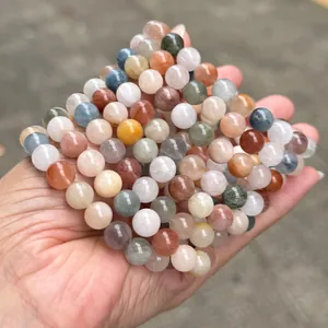 Close-up detail of natural multi-color rabbit hair phantom quartz crystal beaded bracelets