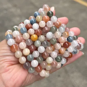 Detailed view of natural colorful rabbit hair rutilated quartz beads bracelet on hand.