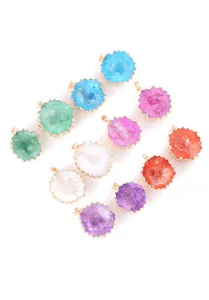 Overhead view of multiple colorful natural crystal druzy agate cave pendants in various shades.