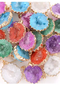 Close-up view of colorful natural crystal druzy agate pendants with gold-plated edges