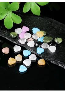 Close-up macro view of assorted colorful heart-shaped natural stone beads for jewelry making