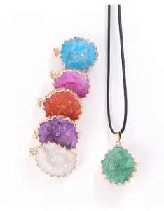 Detailed view of colorful natural druzy agate geode pendants with gold plated edges