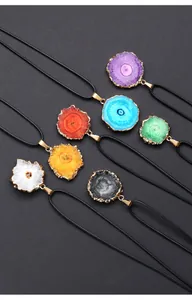 Detailed view of colorful natural agate geode slice pendants with gold-plated edges