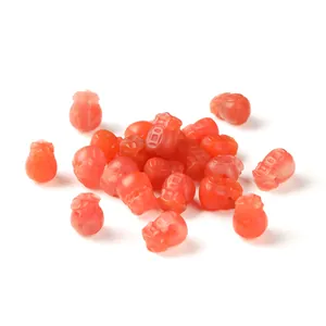 Red Nanhong agate carved lucky bag beads for DIY jewelry making on a white background