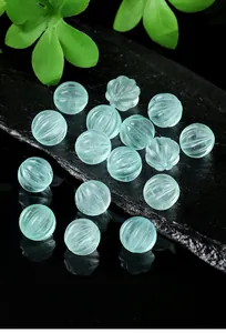 Detailed macro shot of translucent natural green fluorite pumpkin beads for jewelry