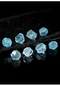 Macro detail of natural light blue faceted topaz gemstones on black slate