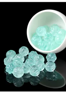 Detailed view of transparent green fluorite pumpkin-shaped carved beads for DIY jewelry