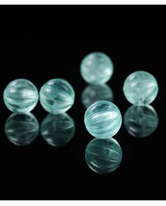 Detailed close-up of translucent mint green fluorite pumpkin beads with ribbed texture
