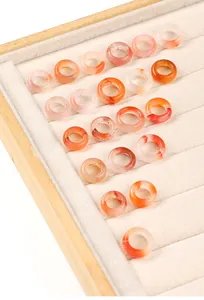 Collection of natural ice-drifting Nanhong agate rings in a jewelry display tray