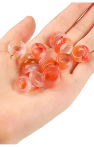 Close-up detail of natural translucent South Red Agate rings showing unique stone patterns.