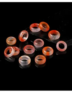 Macro view of natural translucent red carnelian agate rings on black stone