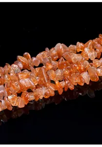 Macro view of natural sunstone irregular beads with sparkling golden aventurescence