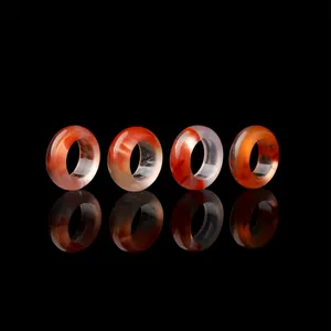 Set of natural ice-float Nanhong agate rings displayed on a black reflective background