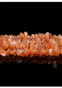 Close-up macro view of irregular natural sunstone chips for DIY jewelry making accessories