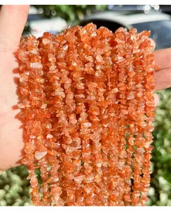 Detailed close-up of natural golden sunstone irregular drilled chips for DIY jewelry making