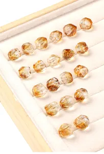 Macro detail of high transparency faceted citrine crystal beads on jewelry tray