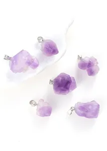 Detailed view of irregular raw lavender amethyst crystal pendants with silver metal bails