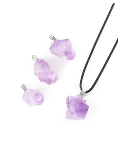 Detail shot of irregular raw amethyst crystal pendants with natural purple textures.