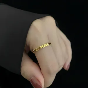 Detailed macro shot of a minimalist gold dollar sign hollow ring on a model hand