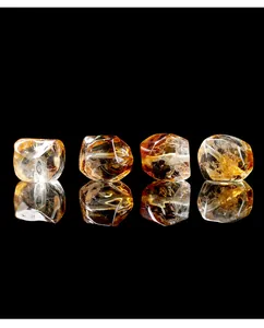 Macro view of transparent faceted Brazilian citrine beads on reflective black background