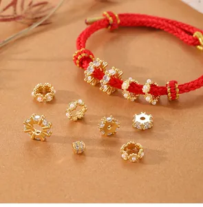 Detailed view of assorted gold-plated zircon and pearl spacer beads for bracelet DIY
