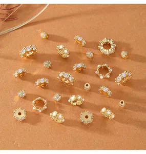 A selection of gold-plated jewelry spacers with cubic zirconia and pearl accents