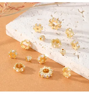 Detailed view of gold-plated spacer beads with cubic zircon inlays and pearl accents