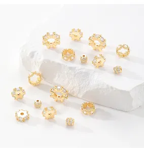 Detailed view of gold-plated spacer beads with micro-inlaid zircons for jewelry.