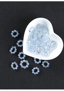 Macro view of ice-translucent blue aquamarine bead rings for DIY jewelry making.