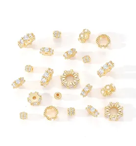 Detailed macro view of assorted gold-plated copper spacer beads with cubic zirconia