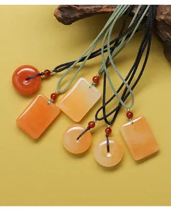Vue détaillée de pendentifs en jade naturel de diverses formes avec d'élégants cordons tressés