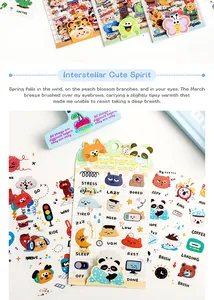 Close-up of cute cartoon sticker sheets with cat and panda designs for journaling