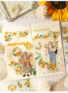 Detailed view of vintage pastoral flower stickers applied on a journal page