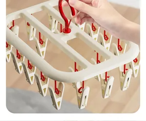 Close-up detail of a cream multi-clip laundry drying rack for socks and baby clothes