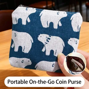 Cute blue canvas coin purse with white polar bear pattern and secure top zipper closure
