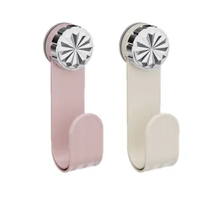 Pair of decorative suction cup hooks in pink and cream for kitchen organization.