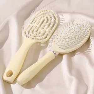 Cream colored hairbrush set with air cushion and vented ribbed brush for hair styling