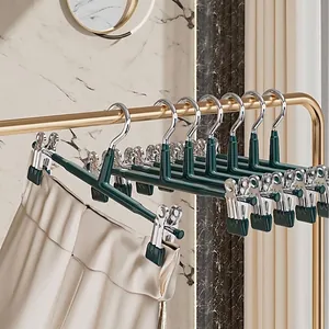 Premium non-marking pants hangers with strong anti-slip clips in elegant dark green